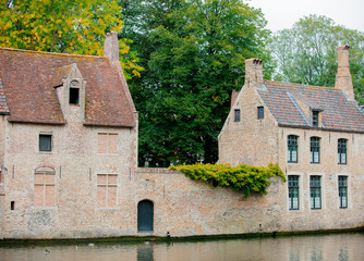 Old medieval houses near a river, fall season. Bruges, Belgium