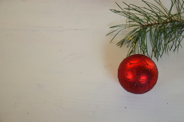 Christmas background with decorations and gift boxes on white wooden board. red ball, gift tied with white ribbon