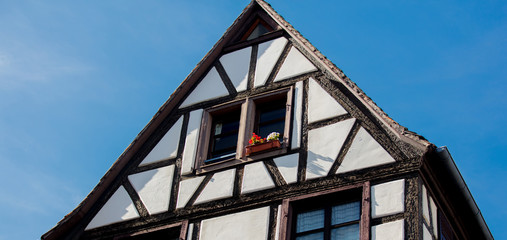 Roof of old medieval house on blue sky background. Strasburg, France.