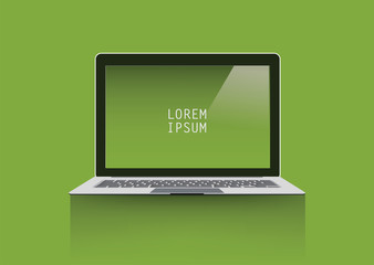 Laptop on green background.
