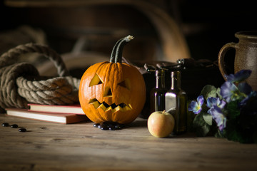 Still life with pumpkin face on halloween in october