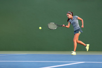 Tennis player man banner hitting ball with racket on green horizontal copy space background. Sports athlete training forehand grip technique on outdoor court.