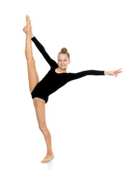 The gymnast balances on one leg.