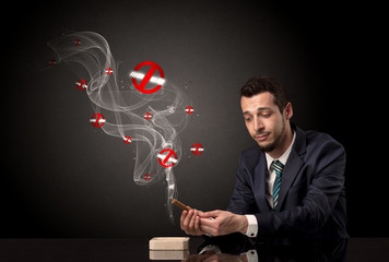 Businessman smoking with colored no smoking symbols nearby.