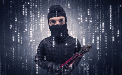 Burglar in action with encoded concept and his tools in his hand. 