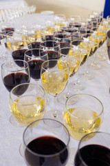 white and red wine in glasses on a banquet table