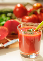 Glass of fresh tomato juice and tomatoes