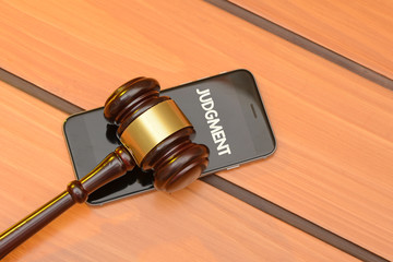 Judgment concerted theme with smart phone on wooden backgorund