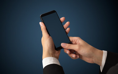 Mockup for female hand using frameless smartphone with dark background
