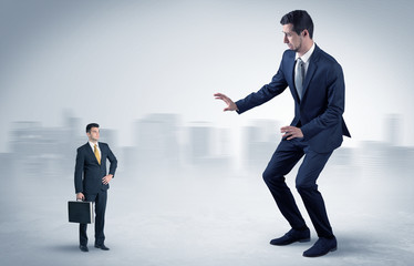 Giant businessman being afraid of small serious executor with suitcase
