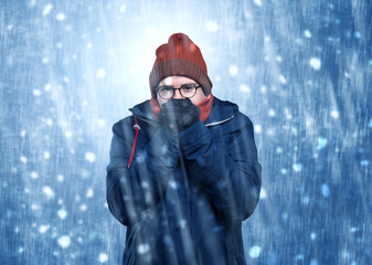 Handsome young boy shivering and trembling at snowstorm concept
