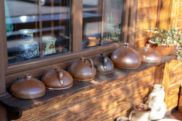 Obraz na płótnie Canvas Old vases and water jugs. Home accessories from the last century set on the windowsill.