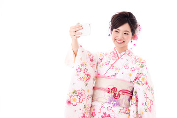 portrait of young asian woman wearing pink kimono on white background
