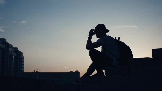 Silhouette of a man in the city at sunset