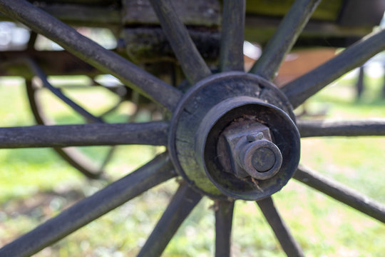 An old wooden wheel from a ladder. Wheel from a wooden wagon from ancient times.