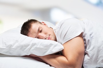 Young beautiful woman sleeping in bed