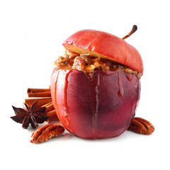 Baked apple with caramel, brown sugar, spices and and nuts isolated on a white background