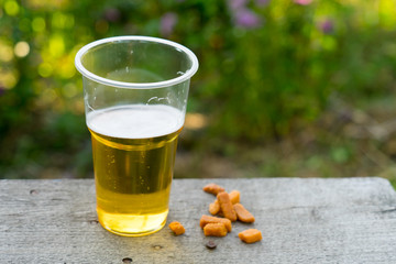 Beer in a plastic Cup. Alcohol at the picnic.