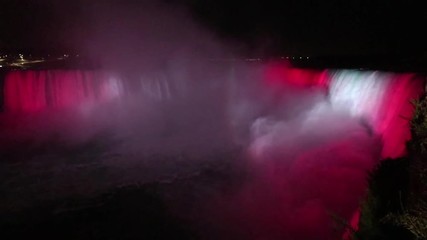 Niagara Falls lit at night by colorful lights