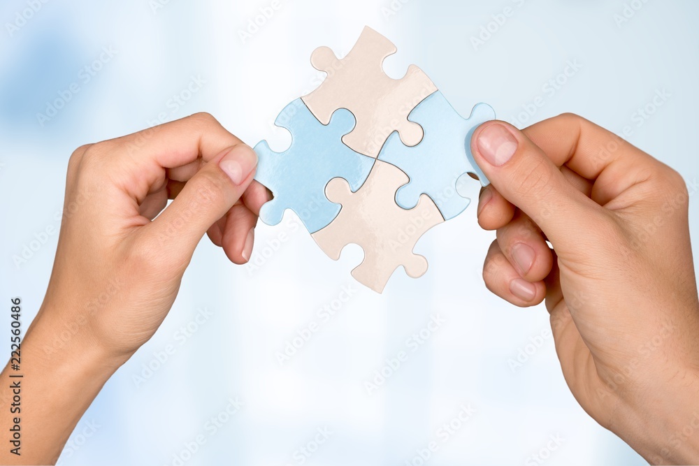 Poster Human hands joining puzzle parts on background