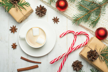 Christmas composition.Coffee with marshmallows, pine cones, spruce branches and lollipops on a...