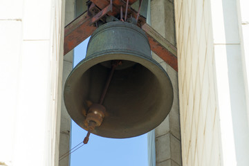 The old bell is fixed under the roof of the chapel.