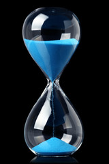 Hourglass with blue sand showing the passage of time