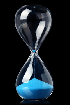Hourglass with blue sand showing the passage of time