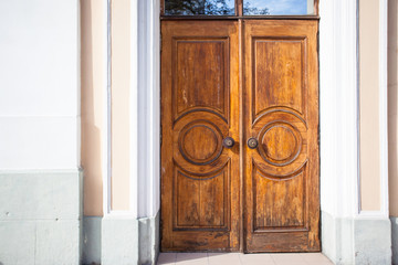 large solid wooden door with scuffs and cracks