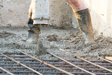 Workers pour the Foundation for the construction of a residential building.