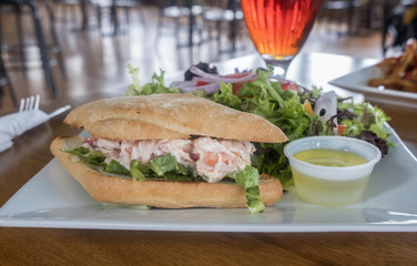 Lobster Roll Served with Green Salad and Beer