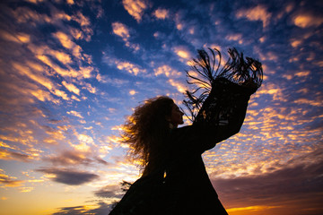 woman silhouette  sunset sky  sleeves flight fringe