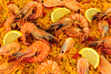Fresh seafood paella with shell on prawns background
