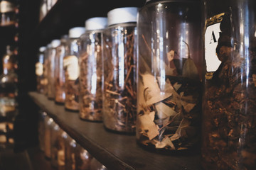 General view of vintage apothecary interior with various ingredients, antique bottles and equipment