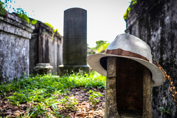 General angled view of old antique cemetery with raised crumbling sepulchers and blue skies