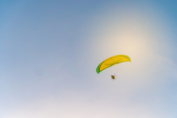 Man is riding para motor in beautiful  sunset cloud sky background.
