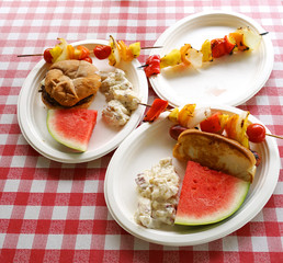 close up on grilled food and fruit in the plates