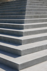 Close up of steep concrete staircase with shadows and angles 