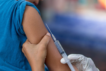 The doctor uses the syringe in the arm. , healthy and medical concept