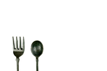 Vintage Iron spoon and fork in black color isolated on white background with copy space for text,...
