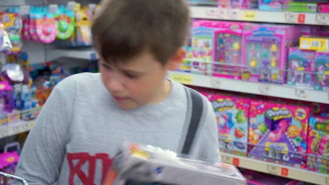 Boy 10-12 years chooses toys. Children's toy store
