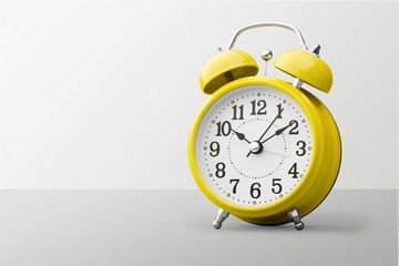 Blue Retro alarm clock on wooden table on wall background