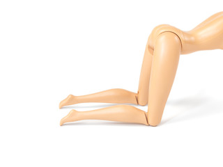 The beautiful slender legs of pretty figure girl doll doing gestures sexy isolated on white background