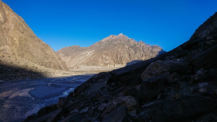 Fototapeta premium Trekking along the Braldu River in the Karakorum Mountains in Northern Pakistan, Landscape of K2 trekking trail in Karakoram range, Pakistan