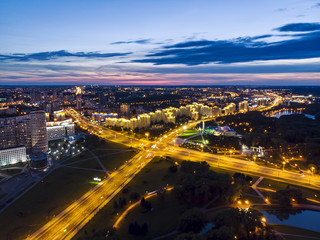 Fototapeta na wymiar Aerial top view of illuminated city road and modern apartment buildings, Minsk, Belarus