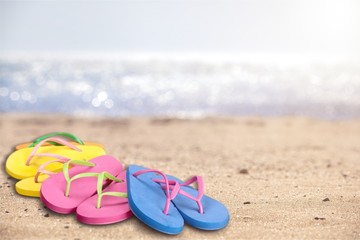 Fototapeta na wymiar Pairs Of Flip-flops On Beach, vacation concept