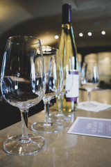 Focus of sparkling wine glasses with bokeh background of winery tasting interior