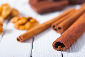 chocolate brownie cake and ingredients, baking papaer on white wood table background