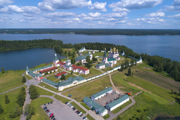 Fototapeta na wymiar View from height on Valdaisky Iversky Bogoroditsky Svyatoozersky monastery in the sunny June afternoon (aerial photography). Novgorod region, Russia