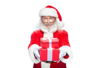 Christmas. Smiling Santa Claus in white gloves is holding two gift red boxes with a bow, one on the other. Isolated on white background.